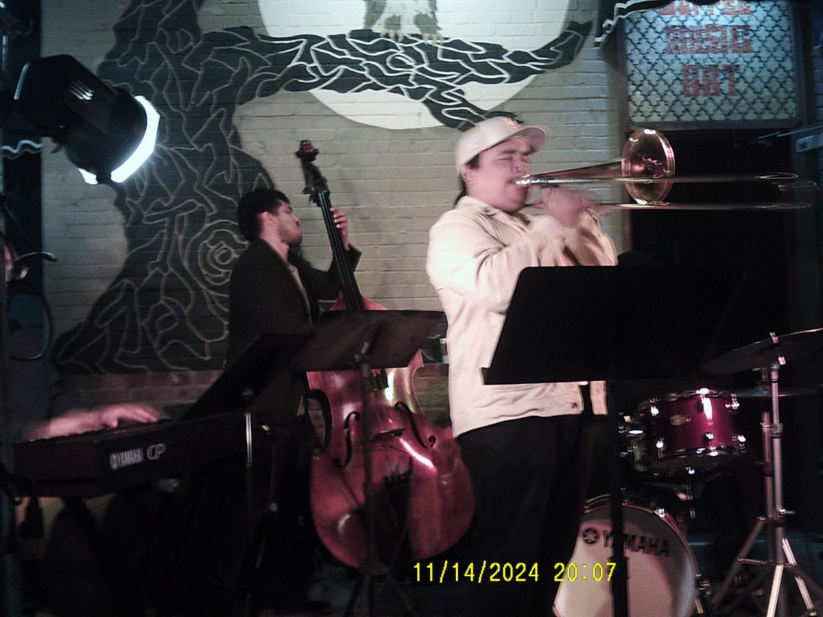 Pictured here are Andy Garcia playing trombone and Carlos Zagal on contrabass, behind them almost unseen are Andrew Yanes playing the drums and Cameron Chavez on keys. 